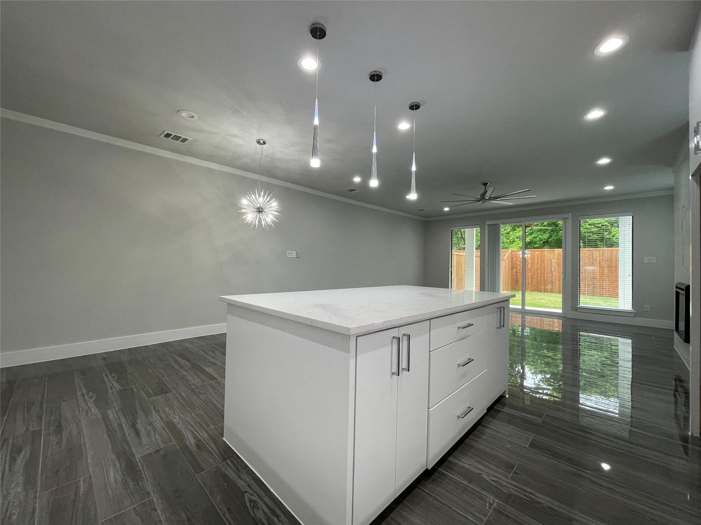 Open kitchen with a quartz island and dining area at 2417 N Winnetka Ave, Dallas