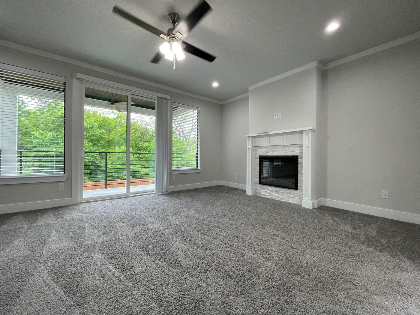 Primary suite with a private fireplace and carpet at 2417 N Winnetka Ave, Dallas