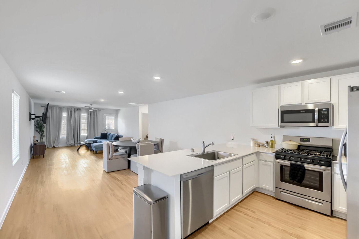 Kitchen with white cabinetry, stainless steel appliances, and a breakfast bar at 2729 Cadiz Bay Dr, Conroe