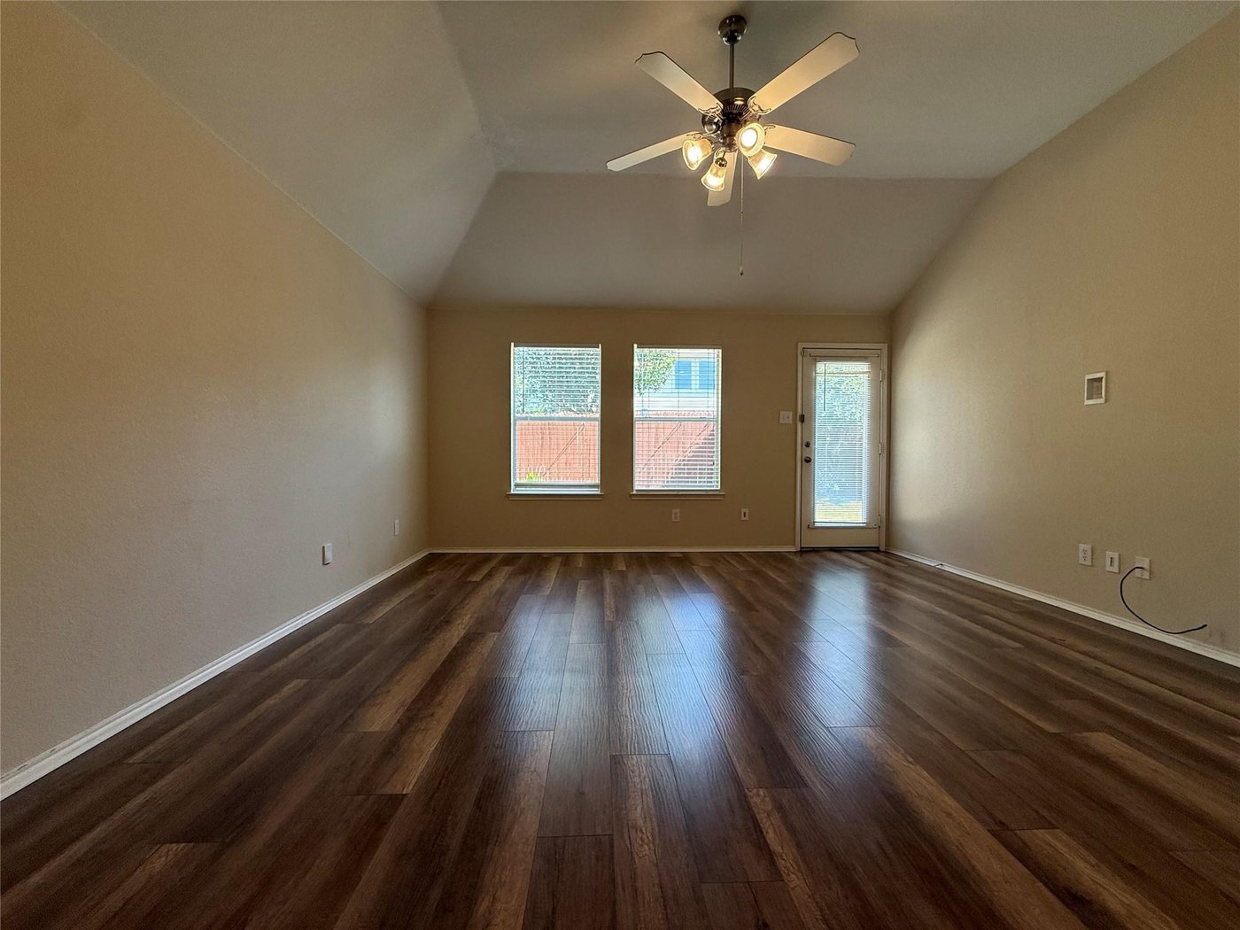 Living room with vaulted ceiling and natural light at 3605 Cottonwood Rd, Melissa