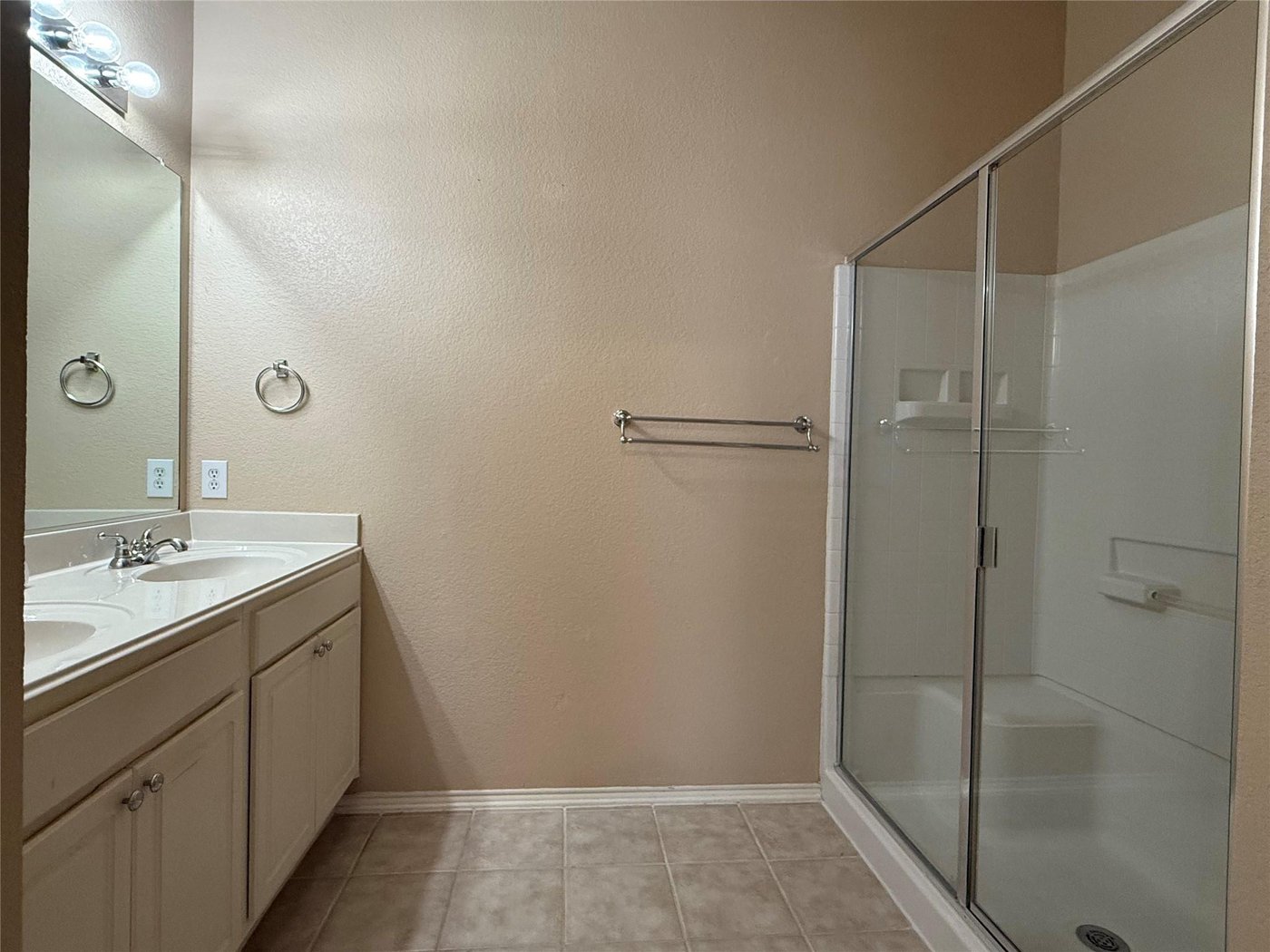 Primary bathroom with dual sinks and a glass shower at 3605 Cottonwood Rd