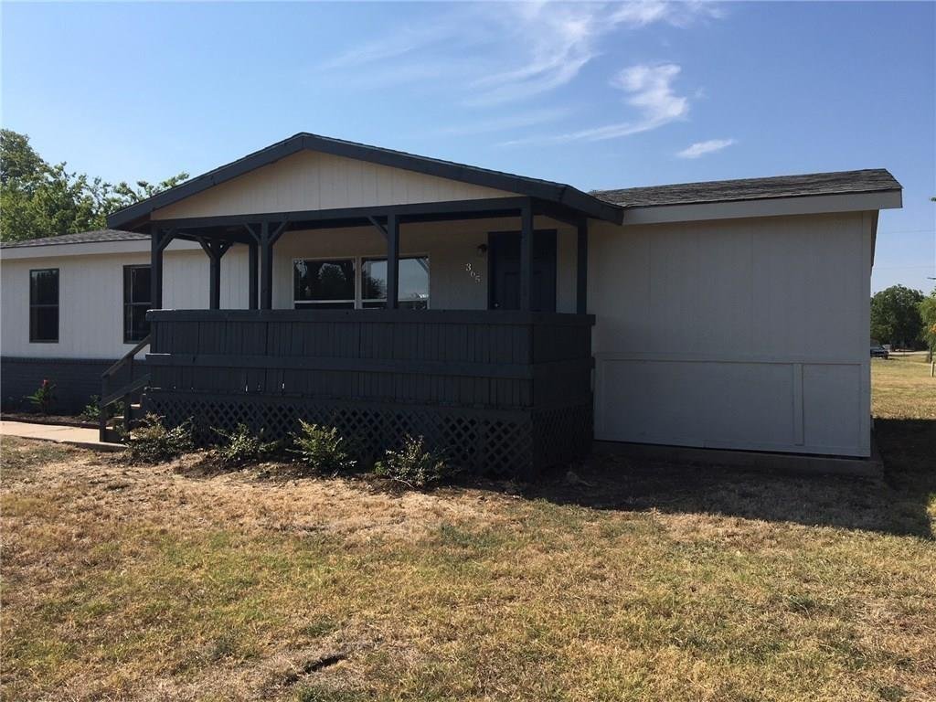 Front exterior of 365 Darrell Rd, an updated single-story home for lease on a half acre corner lot in Roanoke, TX