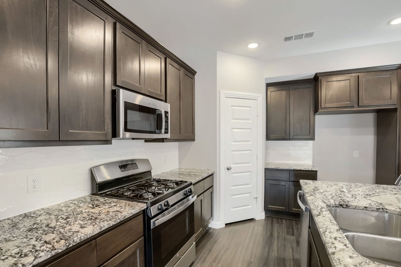 Kitchen with stainless steel gas range and dark cabinetry at 3925 Chesapeake Ln