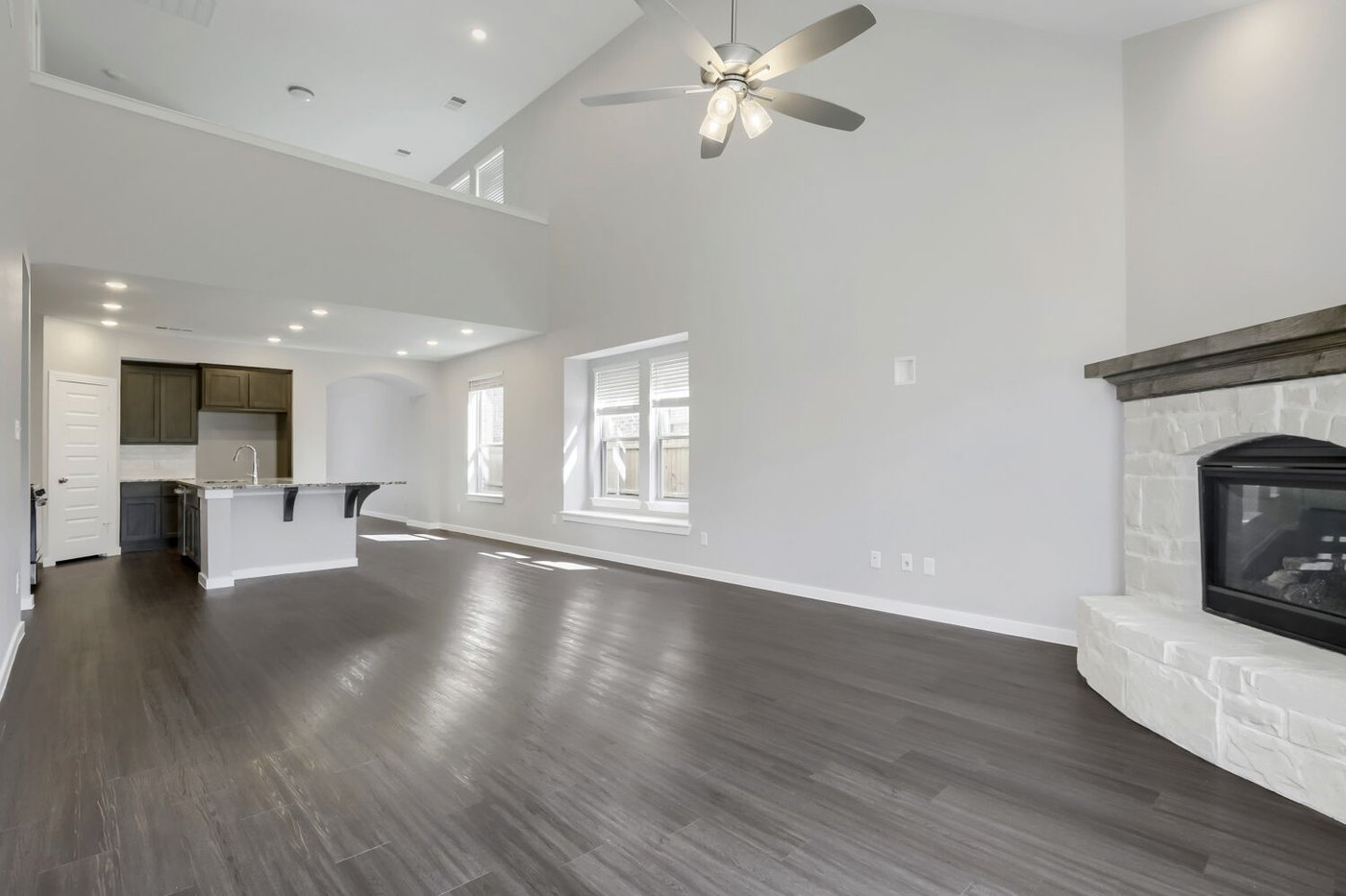 Living room open to the kitchen with natural light at 3925 Chesapeake Ln, Heartland