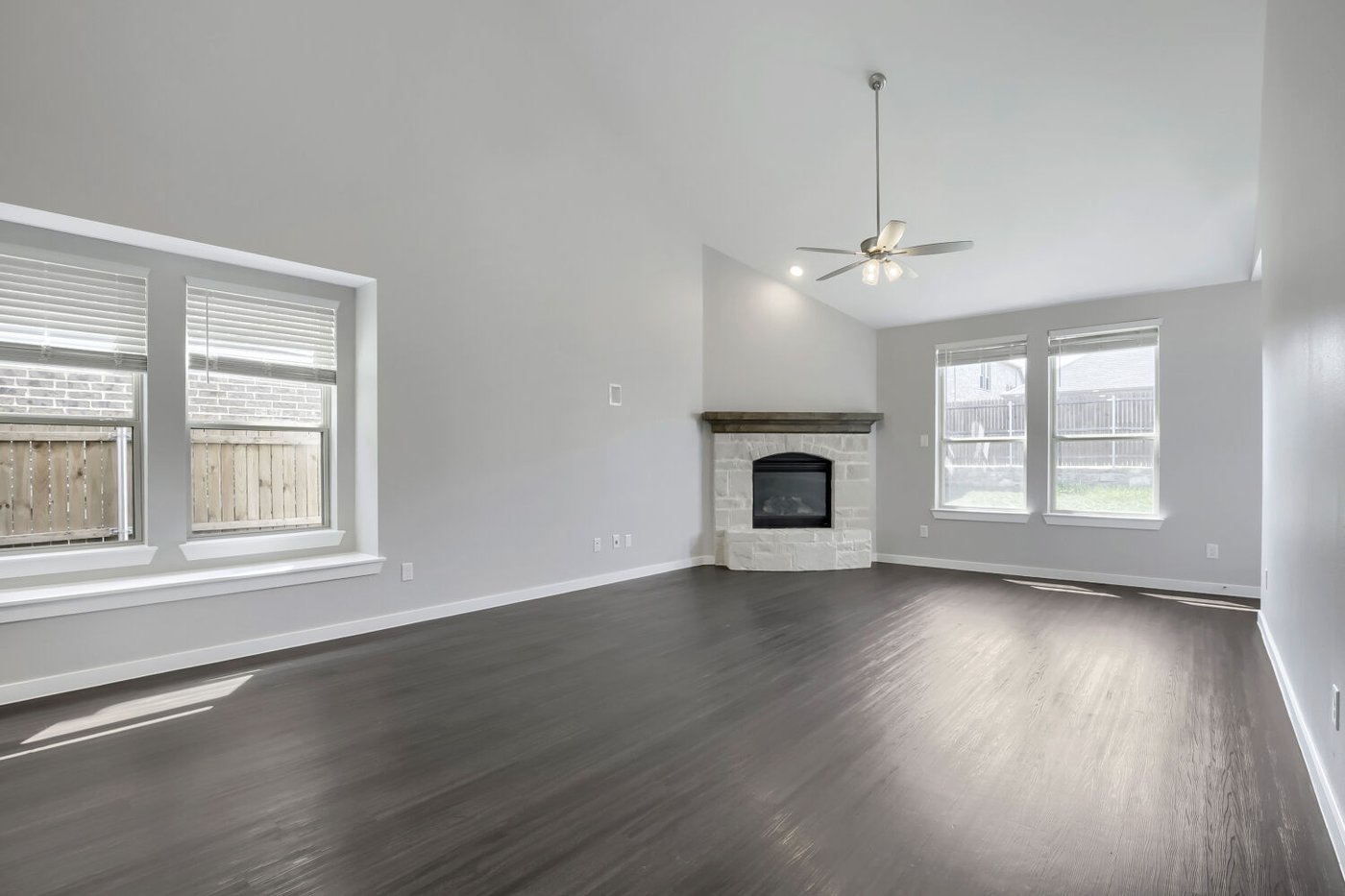 Open concept living room with dark wood look flooring and a fireplace at 3925 Chesapeake Ln