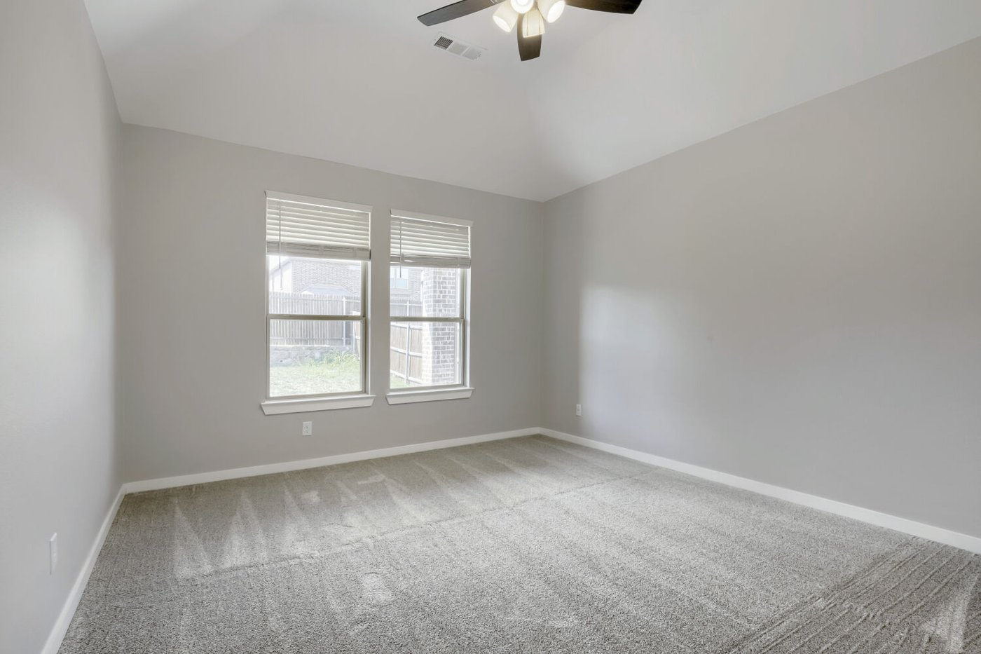 Primary bedroom with new carpet and large windows at 3925 Chesapeake Ln