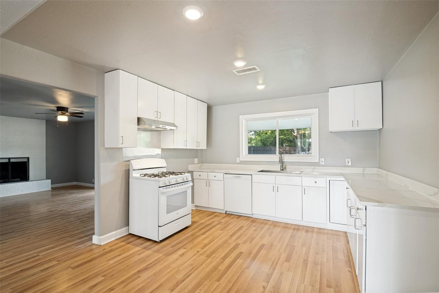 Open kitchen with white cabinetry and a gas range at 4401 Ivy Dr, Mesquite