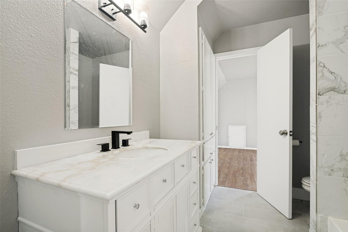 Remodeled bathroom with a marble look vanity at 4401 Ivy Dr, Mesquite