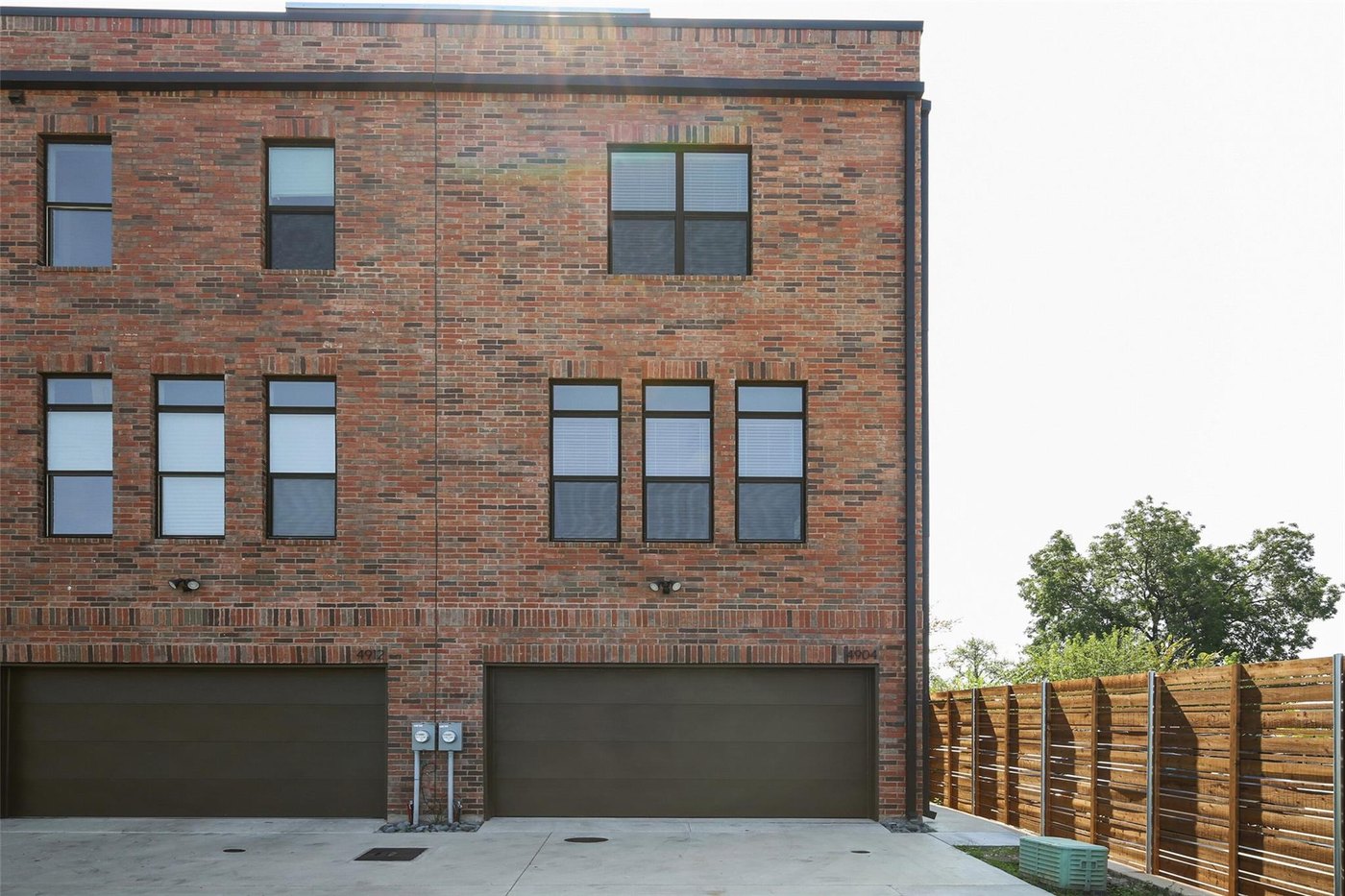 Front exterior of 4904 Lexington Ct, a modern brick corner-unit townhome for lease in Dallas, TX