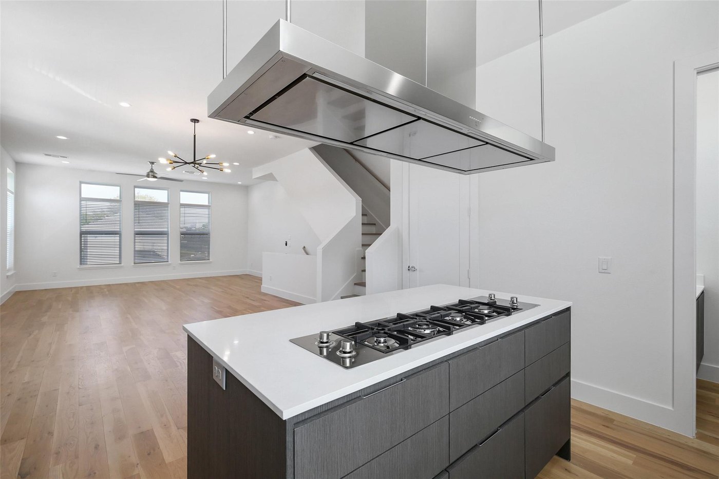Island with gas cooktop and vent hood at 4904 Lexington Ct, Dallas