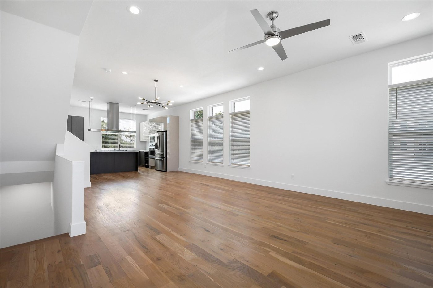 Open living area with wood floors overlooking the kitchen at 4904 Lexington Ct, Dallas