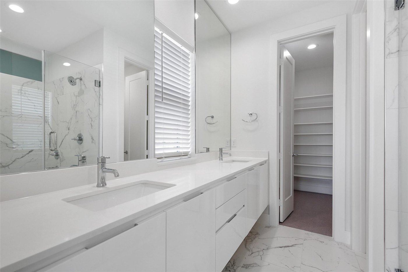 Primary bath with a marble double vanity at 4904 Lexington Ct, Dallas