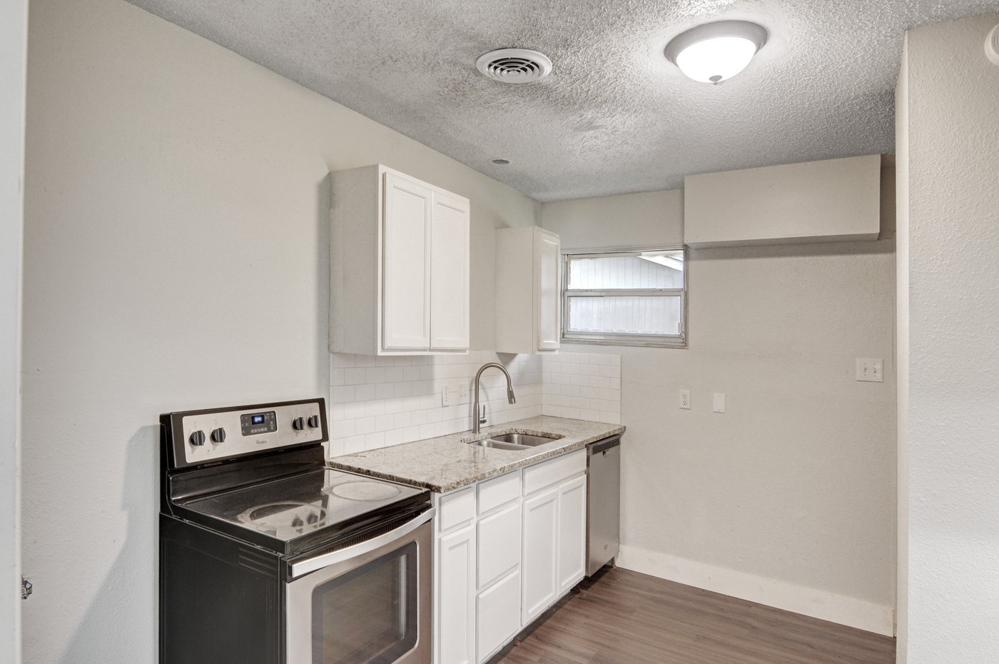 Updated kitchen with granite counters and electric range at 5413 Wedgwood Dr