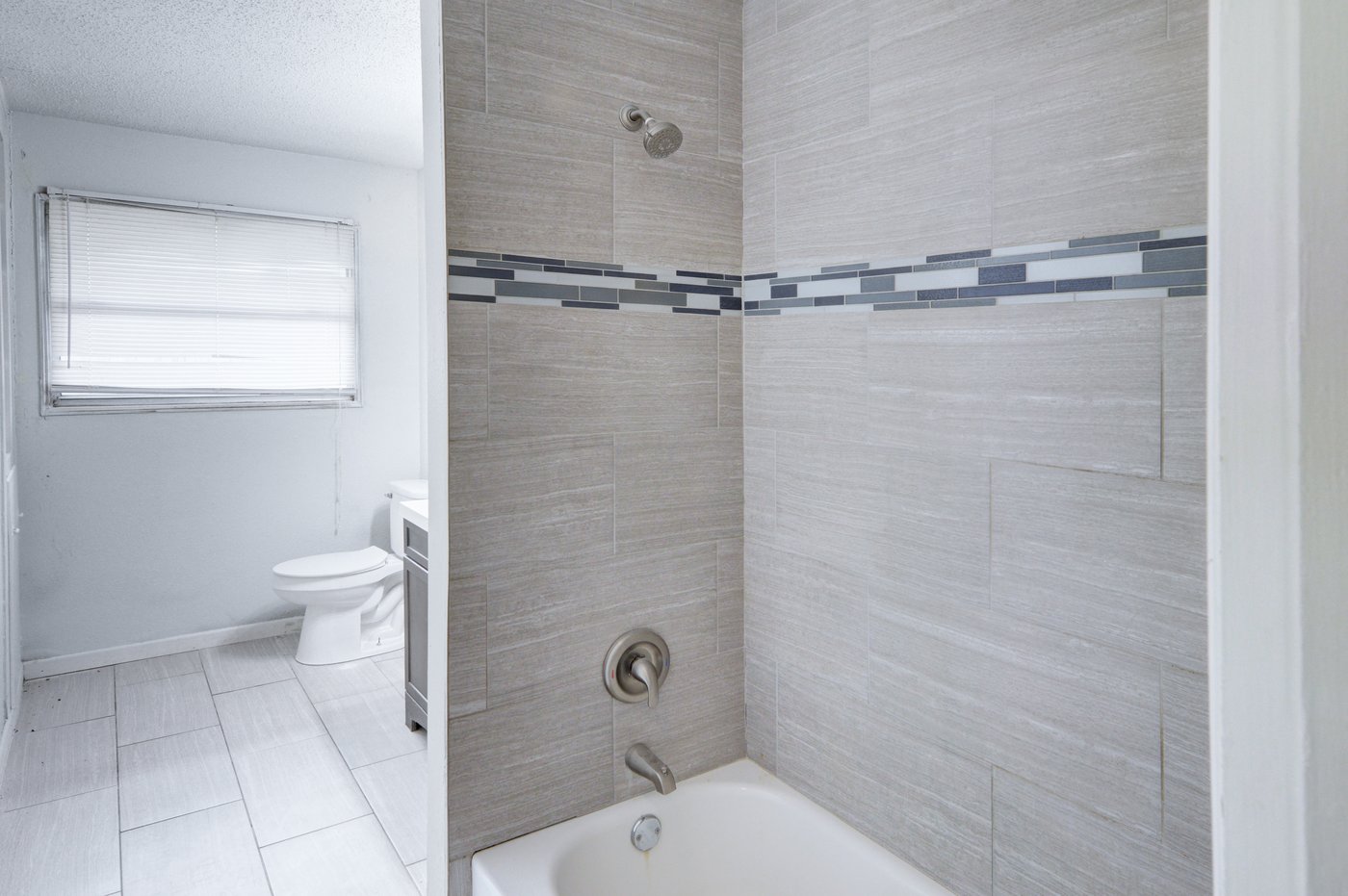 Full bathroom with modern tile shower at 5413 Wedgwood Dr Fort Worth