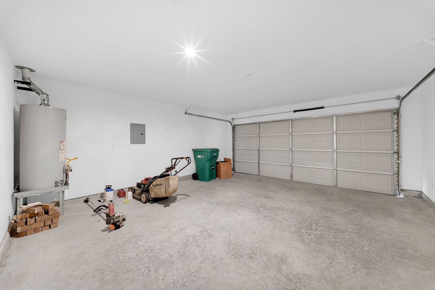 Two car garage with a water heater and storage at 597 Falling Cave Dr, Willis