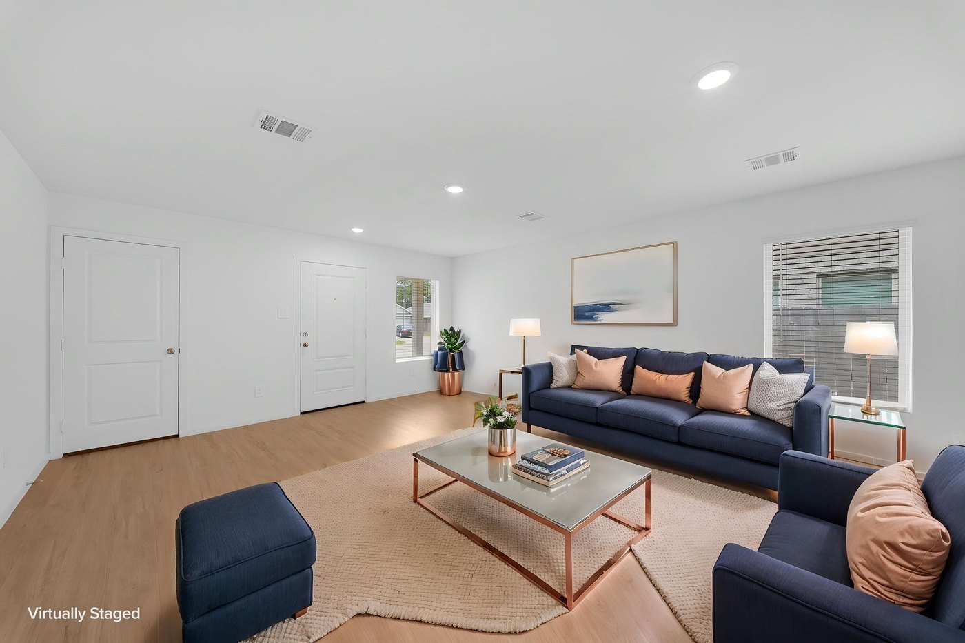 Open living room with wood look flooring and natural light at 597 Falling Cave Dr, Willis