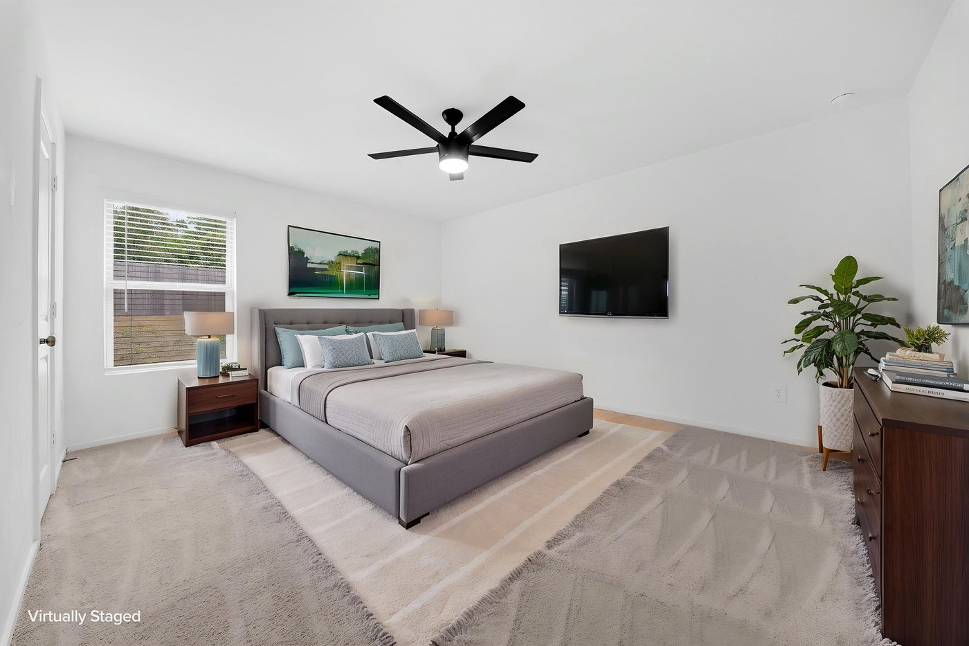 Primary bedroom with a ceiling fan and carpet at 597 Falling Cave Dr, Willis