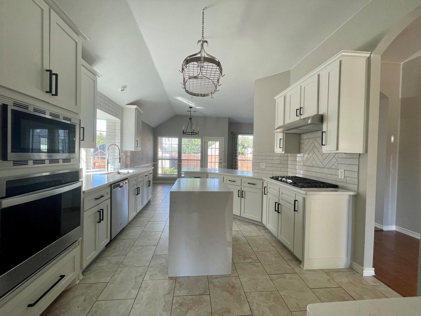 Updated kitchen with island, quartz counters, and stainless appliances at 6505 Josephine Dr, Arlington