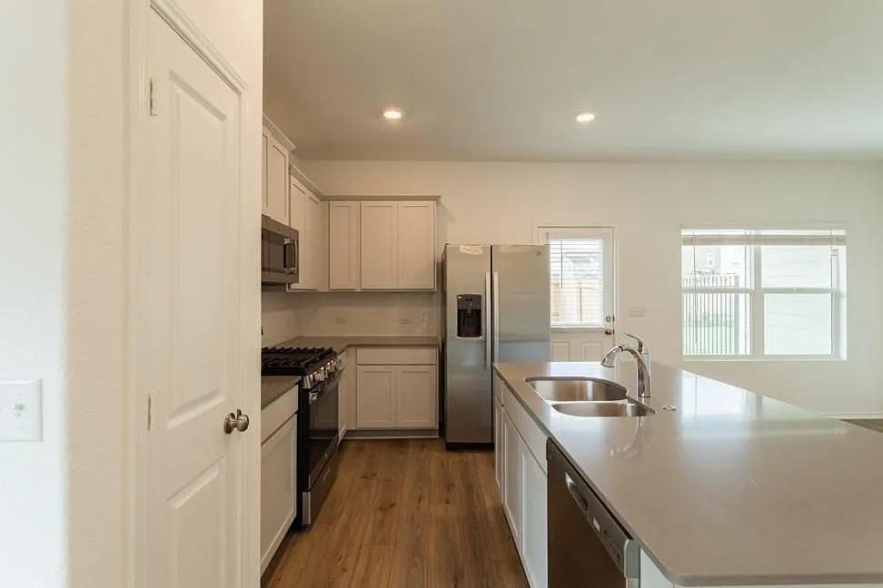 Kitchen with island, stainless appliances, and gas range at 7104 Spotted Leaf Way, Del Valle