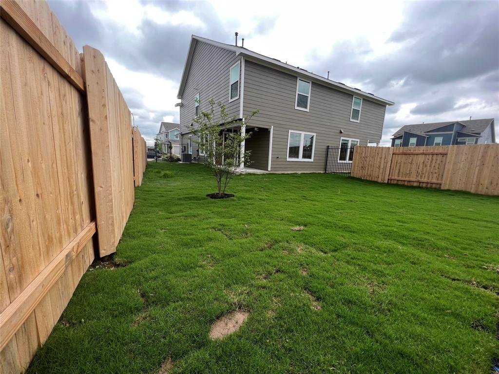Private backyard with a covered porch at 7724 Spotted Leaf Way, Del Valle TX