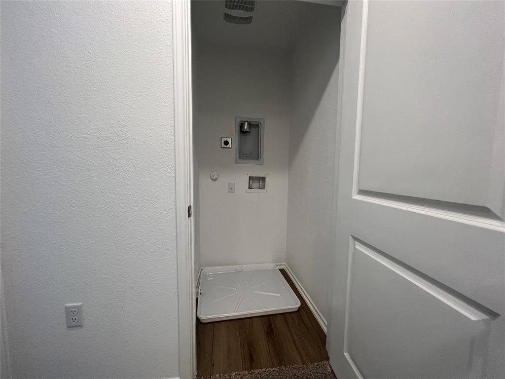 Upstairs laundry room with washer and dryer at 7724 Spotted Leaf Way in Del Valle