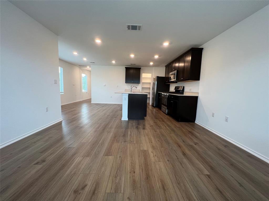 Living room that flows into the kitchen at 7724 Spotted Leaf Way in Del Valle